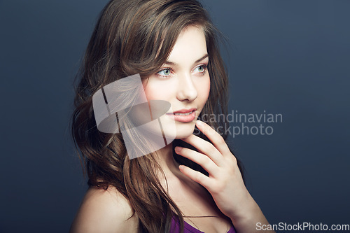 Image of Cosmetic, makeup and woman in a studio with a natural, face and beauty routine. Self care, beautiful and young female model with cosmetics, dermatology or skincare treatment by dark background.