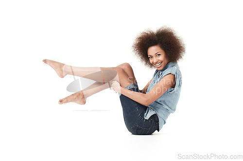 Image of African woman, happy style and portrait holding legs on studio floor with casual fashion. Isolated, white background and young female person with body confidence and modern clothes on the ground