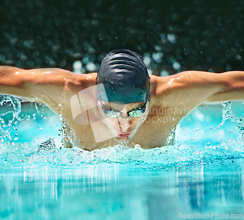 Image of Water splash, sport and training with man in swimming pool for competition, workout and energy. Strong, fitness and cardio with male swimmer and practice for athlete, championship and race at gala