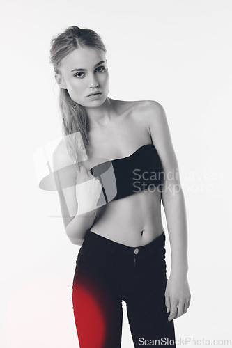 Image of Portrait, attitude and gen z girl in studio for fashion while posing against a white background. Fashionable, face and young female person with confidence or trendy, cool and modern crop top clothing