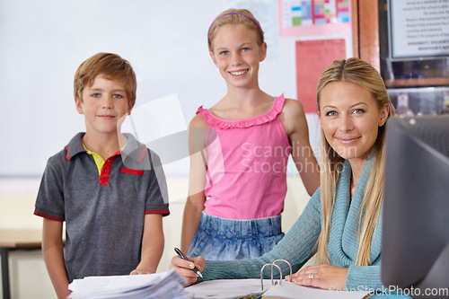 Image of Portrait, kids with teacher and woman in classroom, smile and working in class. Happiness, female educator and group of students learning in elementary school for education, studying or teaching.