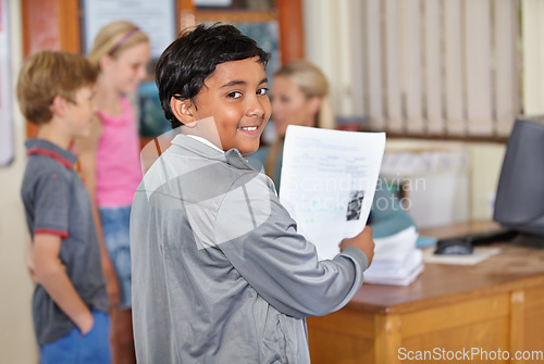 Image of Portrait, child and smile of student with paper in classroom for assignment or class test. Happiness, education and Indian kid with document for studying, learning and assessment in primary school.