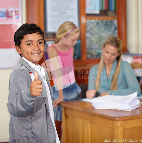 Image of Portrait, child and student with thumbs up, smile and success in classroom. Happiness, hand gesture and kid with like emoji, agreement and approval for learning in elementary school for education.