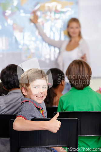 Image of Kid, portrait and thumbs up of student in classroom, elementary school or class. Smile, education and child with hand gesture for like emoji, agreement or learning, success and sign of approval.