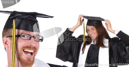 Image of two successful student in graduation gowns 