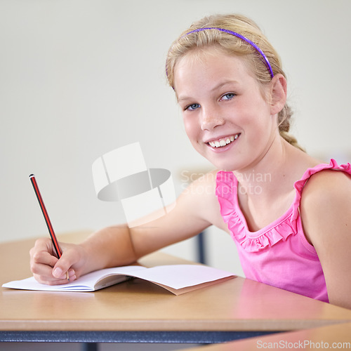 Image of Portrait, child and education of student taking notes in classroom for knowledge, development and happy. Smile, girl and learner writing in notebook, studying or learning in middle school in Canada.