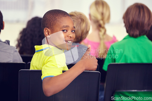 Image of Portrait, black kid and thumbs up of student in classroom, elementary school or class. Smile, education and child with hand gesture for like emoji, agreement and learning, success and approval sign.