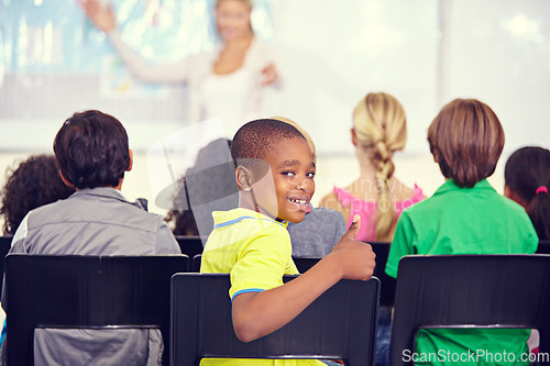 Image of Portrait, black kid and thumbs up of student in class, elementary school or classroom. Smile, education and child with hand gesture for like emoji, agreement and learning, success and approval sign.