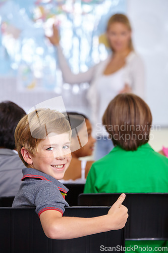Image of Child, portrait and thumbs up of student in classroom, elementary school or class. Smile, education and kid with hand gesture for like emoji, agreement or learning, success and approval sign.