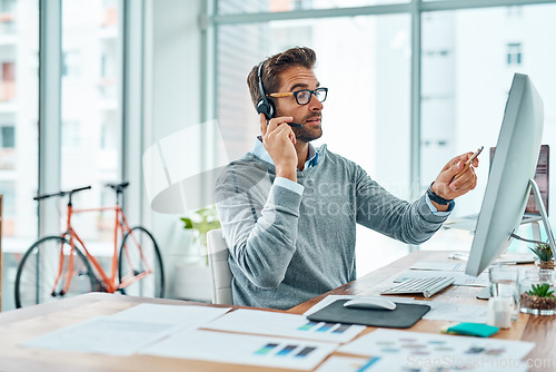 Image of Call center, consultant and man talking advice and insurance consulting with internet telemarketing sales in agency office. Young, computer and male employee working on customer service for support