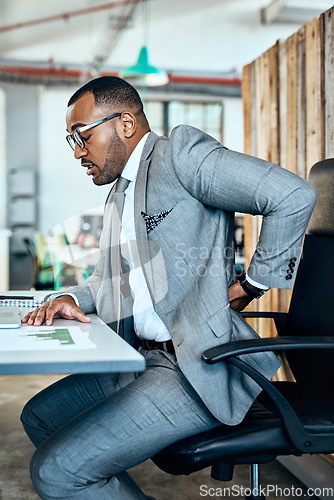 Image of Business man, back pain and stress with injury, bad posture and burnout with medical problem at office. Male corporate person at desk with backache, anatomy and health crisis with muscle tension