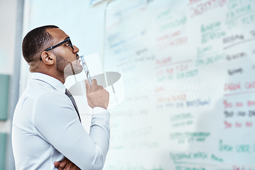 Image of Thinking, planning and business man on whiteboard brainstorming, ideas and information or problem solving. Professional African person or corporate worker reading, solution and project notes on board