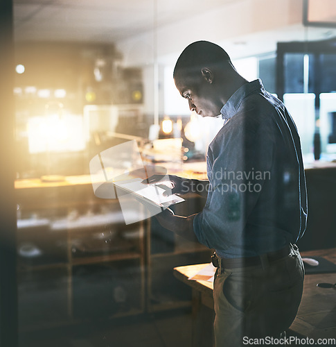 Image of Professional black man, tablet and night business, information technology and software update. Male programmer work late, overtime and deadline with focus, concentration and cyber security upgrade