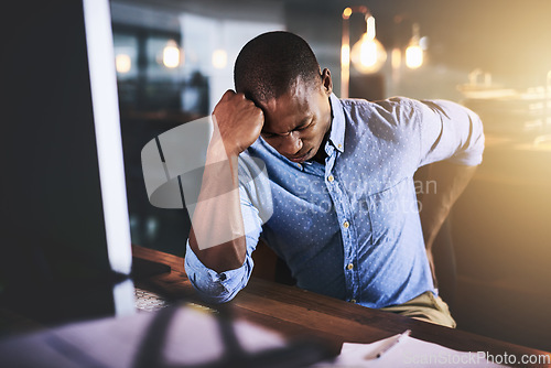 Image of Black man with back pain, night at office and stress with injury, health problem and burnout from overtime. Male business person work late, backache and medical emergency, bad posture and overworked