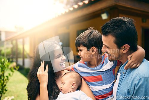 Image of Happy family, smile or hug with children bonding or relaxing together on holiday weekend in backyard. Indian mother, father or kids outside home smiling or hugging a newborn baby with happiness