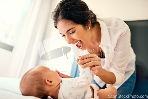 Image of Happy, children and a mother with her baby in the bedroom of their home together for playful bonding. Family, love and a young mama spending time with her newborn infant on the bed for fun or joy