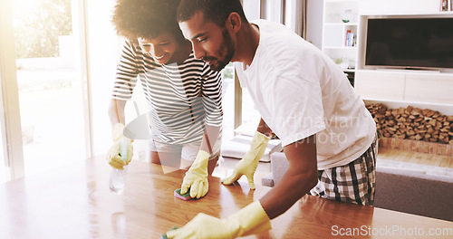 Image of Spray, couple and cleaning table in home for housekeeping, maintenance and responsibility. Man, woman and wipe furniture surface with sponge, detergent and chemical of dust, bacteria and disinfection