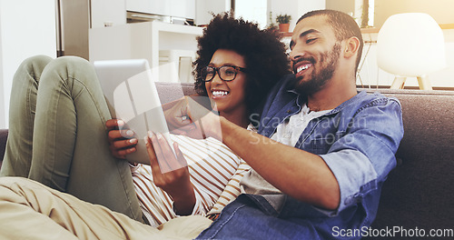 Image of Happy, home and couple on a couch, tablet and bonding with romance, typing and watching a film. Partners, man and woman on a sofa, technology and conversation with movie, network and internet search