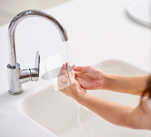 Image of Tap, water and woman cleaning hands for skincare, beauty and safety of bacteria, virus and healthy dermatology at home. Closeup of person washing palm of hand at basin in bathroom for hygiene routine