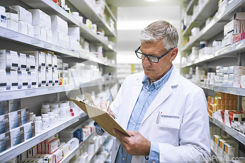 Image of Pharmacy, medicine and checklist with man writing in drug store for notes, inspection and inventory. Medical, healthcare and pills with male pharmacist in clinic for mature expert or wellness product