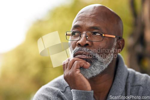 Image of Senior man, face and thinking outdoor in nature to remember memory, idea or vision. Headshot of an elderly African male person think or planning future, life insurance or retirement at a park