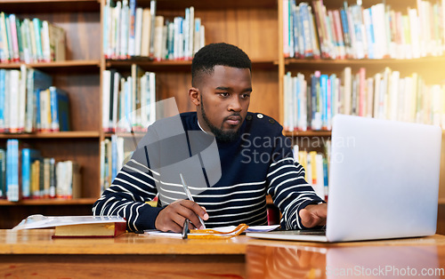 Image of Laptop, library and university student with research, learning and planning for exam, report or focus on studying, goals and education. Black man, college and working on task, essay or scholarship