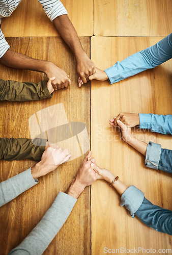 Image of Hands holding, support and people planning together for prayer circle, love and care in a team building table. Above, community and group teamwork by employees with hope, collaboration and help