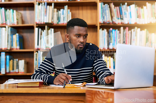 Image of University. library and student on laptop with research, planning or learning for exam, report or focus on studying, goals and education. Black man, college and working on task, essay or scholarship