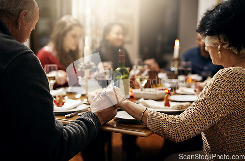 Image of Food, thanksgiving and hand holding with family at table in dining room for holiday, prayer or worship. Celebration, support and gratitude with people praying at home for kindness, dinner and love