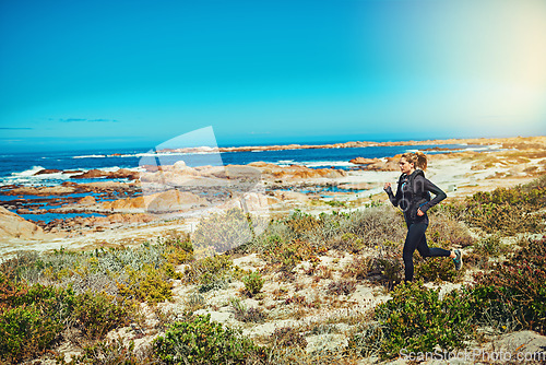 Image of Woman running, beach and fitness outdoor with cardio and training for marathon with young athlete and sports. Female runner in nature, ocean and run for exercise with healthy person and mockup space