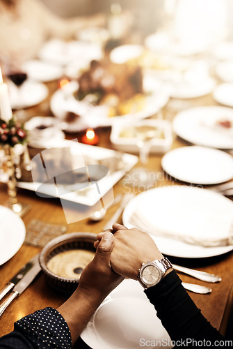 Image of Prayer, holiday and hand holding with family at table in dining room for party, food or worship. Celebration, support and gratitude with closeup of praying people at home for kindness, dinner or love