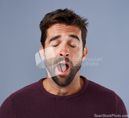 Image of Tired, yawn and man in studio for fatigue or low energy against a grey background. Exhausted, yawning and face of bored male sleepy, lazy or suffering from insomnia, problem or burnout with emoji