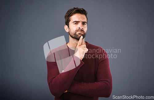 Image of Doubt, thinking and portrait of man in studio with unsure, uncertain and thoughtful on gray background. Confused, mockup space and face of male person skeptical for decision, choice and question