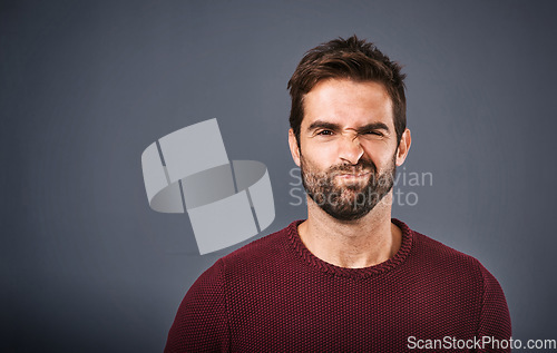 Image of Doubt, confused and portrait of man in studio with unsure, uncertain and thoughtful on gray background. Thinking, mockup space and face of male person skeptical for decision, choice and question