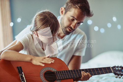 Image of Man, girl and kid in guitar teaching and learning at home, bonding with love and creativity. Family, father and daughter learn to play musical instrument, focus in lesson and music education help