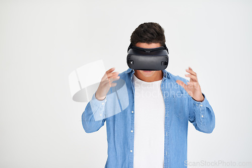 Image of Man, vr and and futuristic technology on mockup standing amazed against a white studio background. Male in virtual reality, metaverse or future innovation with digital headset on mock up space