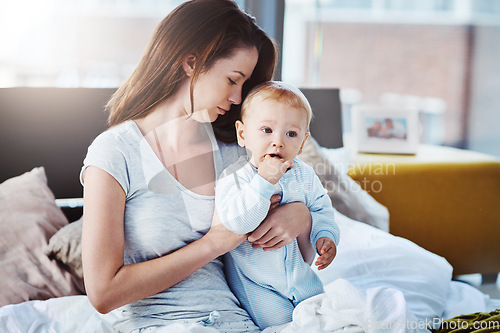 Image of Mother, baby and morning in bed with care, support and love for newborn boy, calm mama and together in home. Mom, child and peace in motherhood, childcare and tired postpartum parent or hug infant