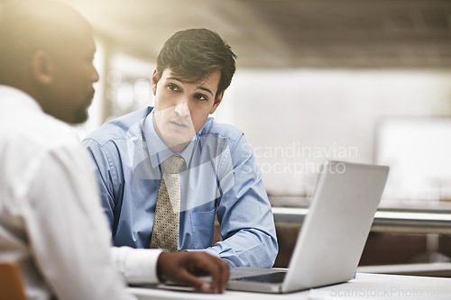 Image of Laptop, serious conversation and business men in the boardroom for meeting to discuss the company vision. Collaboration, computer and review with an employee team sitting together in the office