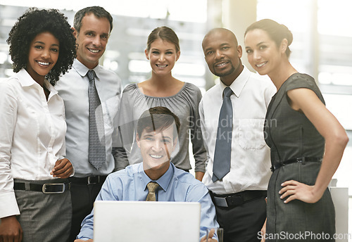Image of Portrait, laptop and a group of business people working together in collaboration on a project in their office. Teamwork, computer and corporate with an employee meeting in the boardroom for planning