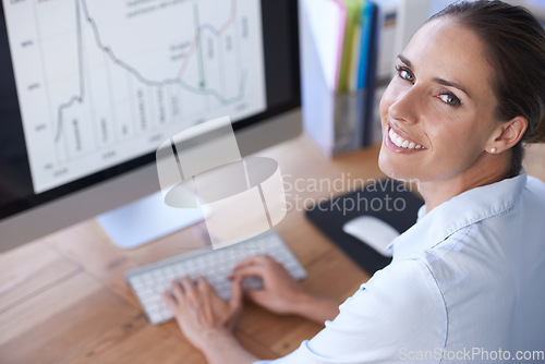 Image of Portrait, business and happy woman at computer with graphs, stock market trading and data analysis. Female worker, typing and desktop for research, analytics and planning infographics for kpi review