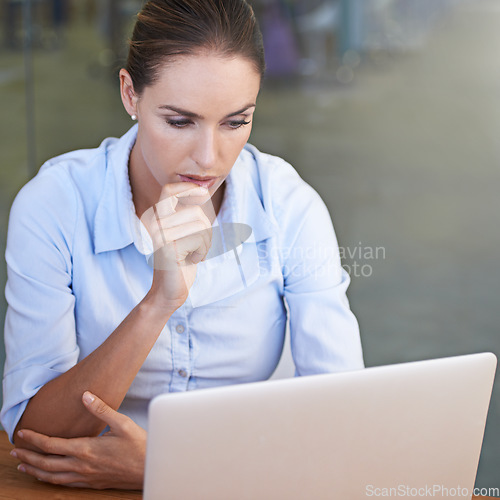 Image of Business, serious woman and thinking face at laptop for research ideas, planning solution and online decision. Focused female worker at computer for insight, reading email and review tech information