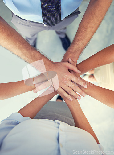 Image of Top view, hands and team of business people with motivation, support and winning in success, target and trust. Hand huddle, stack and group cooperation for mission, partnership goals and faq about us