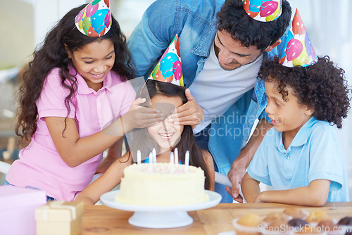 Image of Birthday cake surprise, party or happy family kids excited for special event, dessert food or celebration snack. Eyes covered, excitement and fun friends, dad and group of children smile for girl