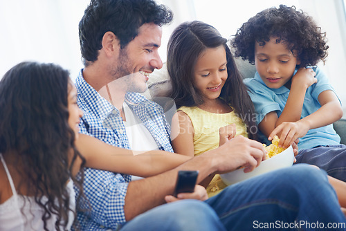 Image of Happy family, relax father and children with food, eating meal and hungry while watching tv, film or home entertainment. Bonding, snack and youth kids, dad or group enjoy quality time together