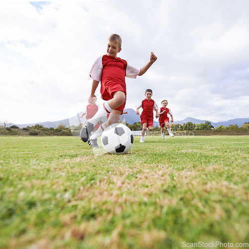 Image of Running, kick and sports with children and soccer ball on field for training, competition and fitness. Game, summer and action with football player on pitch for goals, energy and athlete