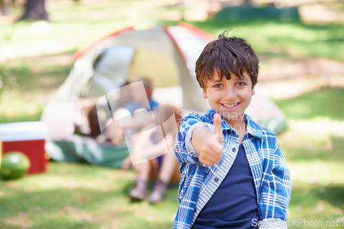 Image of Happy kid, portrait smile and thumbs up for camping success, winning or victory in nature. Little boy or child smiling and showing thumb emoji, yes sign or like for camp setup, victory or approval