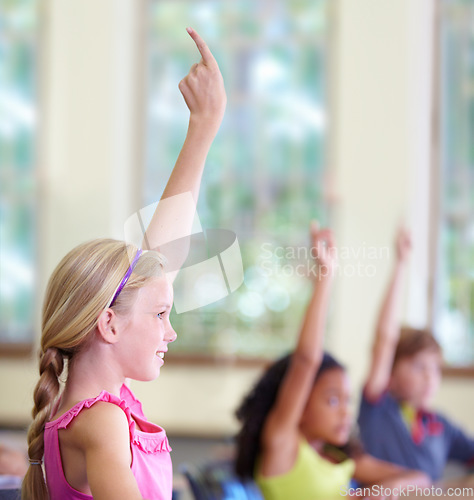 Image of Education, children and classroom or raise hands on school desk or excited kids for test and learning on bokeh. Knowledge, study and table for asking or exam answer or growth and child development