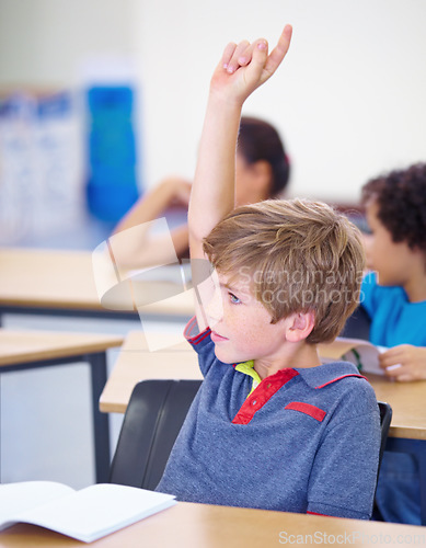 Image of Classroom, child and raise hand for questions, support and help with education and teaching in school or classroom. Young boy or kid with arm up for knowledge, learning and class answer or advice
