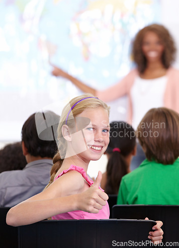 Image of Thumbs up, classroom and child portrait for happy learning, support and thank you sign for education success, school or geography. Like, yes and achievement hand or emoji of girl kid in map teaching