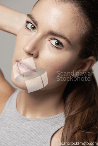 Image of Portrait, woman model and natural beauty with facial cosmetics or skincare and on grey background. Closeup, face and girl with clean makeup or healthy dermatology or lip balm and in studio